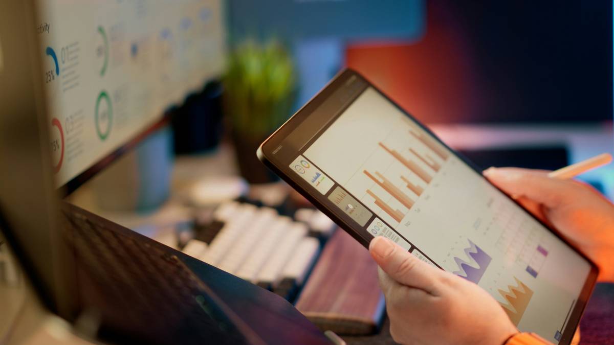 Smartphone showing a coaching app dashboard with Goal Monitoring metrics for budgeting and savings targets